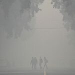 Air pollution haze over a major Indian city with monitoring graph overlay