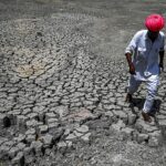 Volunteers assisting residents inside a cooling center with water stations