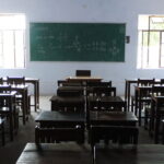 Classroom desks in an Indian school used as a representational image